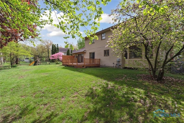 view of grassy yard featuring a wooden deck