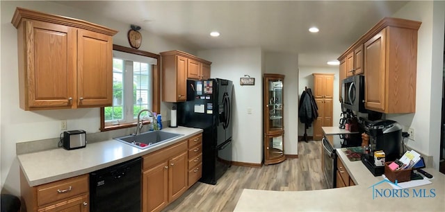 109 Rivers Edge Ln Unit C, Upper Sandusky, OH 43351 - kitchen with a sink, black appliances, light wood-type flooring, light countertops, and recessed lighting