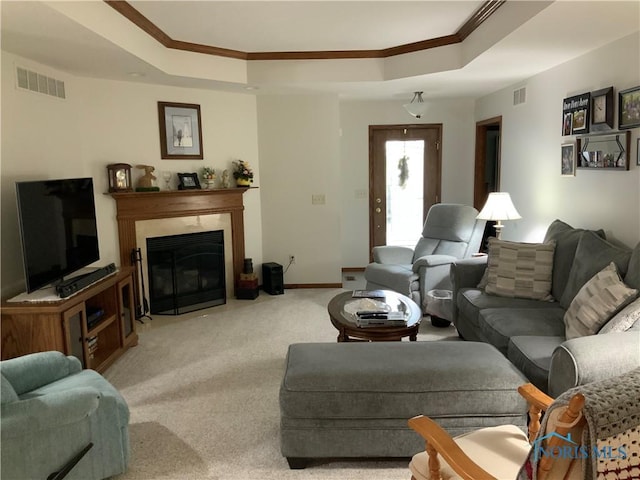 109 Rivers Edge Ln Unit C, Upper Sandusky, OH 43351 - living area with crown molding, a raised ceiling, carpet flooring, a fireplace with flush hearth, and baseboards