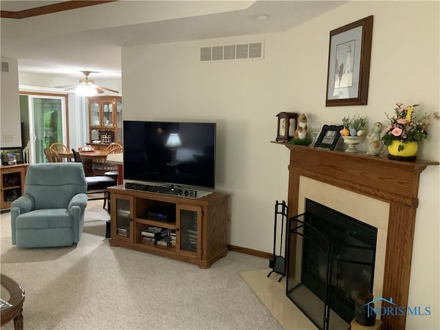 109 Rivers Edge Ln Unit C, Upper Sandusky, OH 43351 - living room featuring a ceiling fan, light carpet, and a fireplace with flush hearth