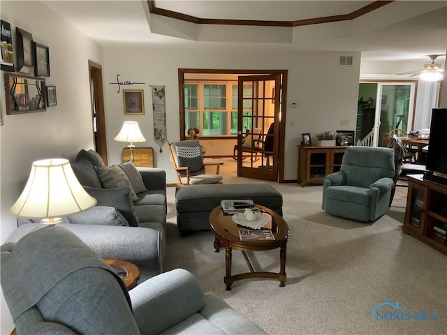 109 Rivers Edge Ln Unit C, Upper Sandusky, OH 43351 - carpeted living room featuring ornamental molding, ceiling fan, a raised ceiling, and baseboards