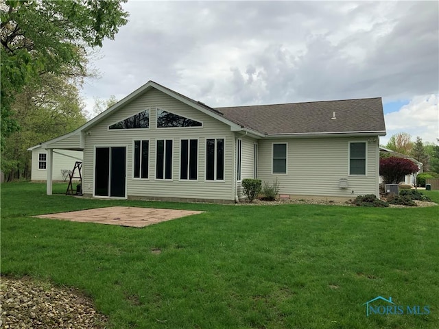 109 Rivers Edge Ln Unit C, Upper Sandusky, OH 43351 - rear view of house featuring a patio, a lawn, and roof with shingles