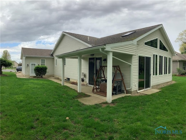109 Rivers Edge Ln Unit C, Upper Sandusky, OH 43351 - back of property with a lawn, a patio, and a shingled roof