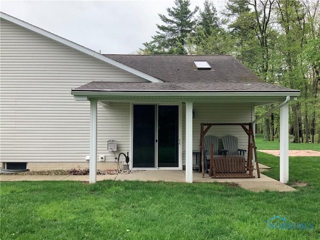 109 Rivers Edge Ln Unit C, Upper Sandusky, OH 43351 - rear view of house with a yard, a shingled roof, and a patio area