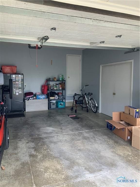 109 Rivers Edge Ln Unit C, Upper Sandusky, OH 43351 - garage with black fridge and a garage door opener