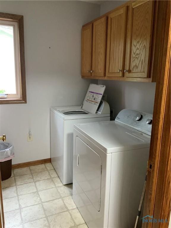 109 Rivers Edge Ln Unit C, Upper Sandusky, OH 43351 - washroom featuring washer and clothes dryer, cabinet space, baseboards, and light floors