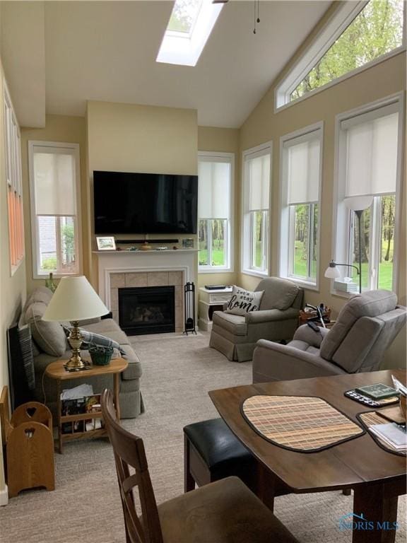 109 Rivers Edge Ln Unit C, Upper Sandusky, OH 43351 - carpeted living room with plenty of natural light, a fireplace, a skylight, high vaulted ceiling, and ceiling fan