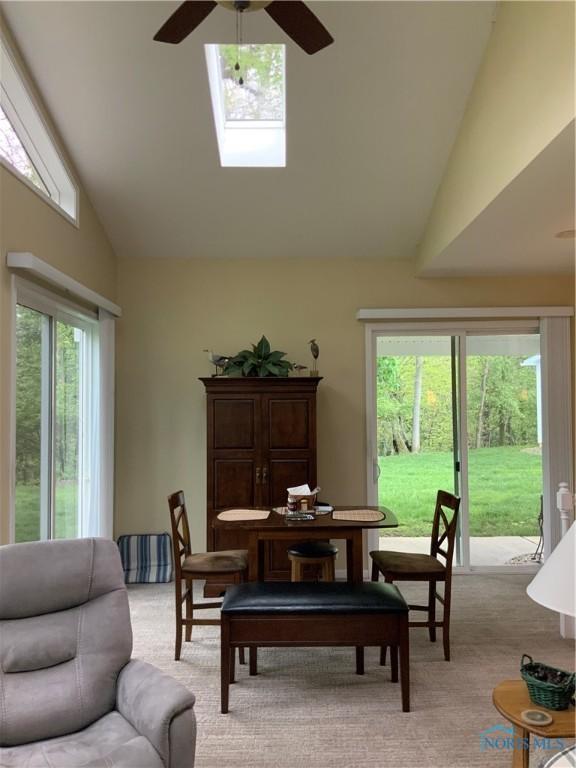 109 Rivers Edge Ln Unit C, Upper Sandusky, OH 43351 - dining space featuring ceiling fan, high vaulted ceiling, light colored carpet, and a skylight