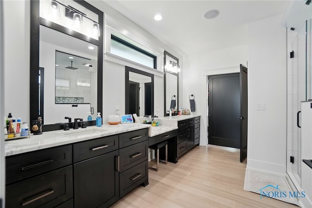 8440 E Woodland Trl, Findlay, OH 45840 - full bathroom with a shower stall, vanity, wood finished floors, and baseboards
