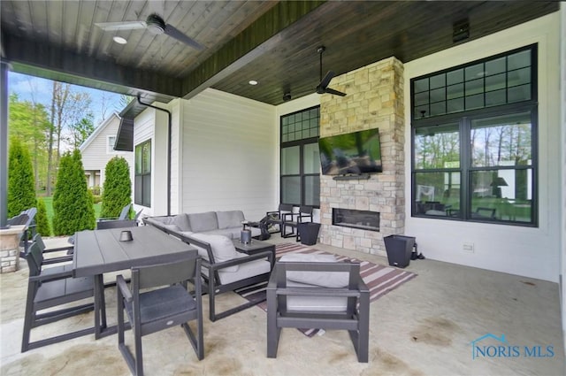 8440 E Woodland Trl, Findlay, OH 45840 - view of patio / terrace featuring a ceiling fan, an outdoor living space with a fireplace, and outdoor dining area