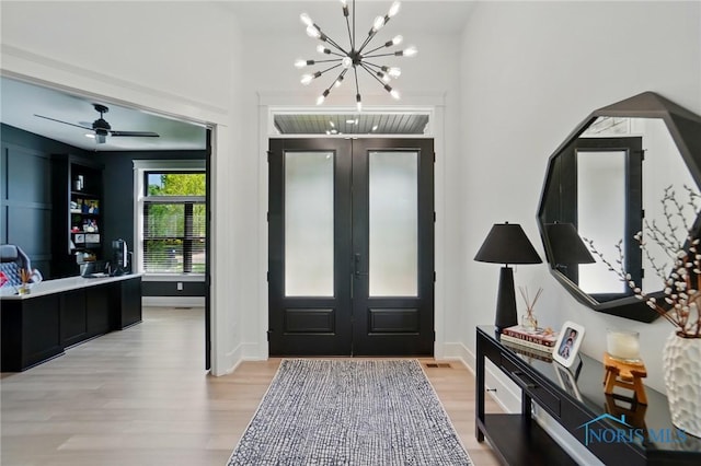 8440 E Woodland Trl, Findlay, OH 45840 - entryway with light wood-type flooring, french doors, a chandelier, and a ceiling fan