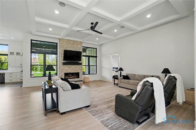 8440 E Woodland Trl, Findlay, OH 45840 - living room with a ceiling fan, coffered ceiling, light wood-style flooring, beam ceiling, and a fireplace
