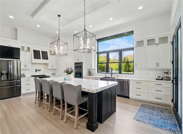 8440 E Woodland Trl, Findlay, OH 45840 - kitchen with appliances with stainless steel finishes, a sink, a chandelier, recessed lighting, and tasteful backsplash