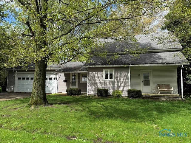 back of house with an attached garage, a porch, a lawn, asphalt driveway, and roof with shingles