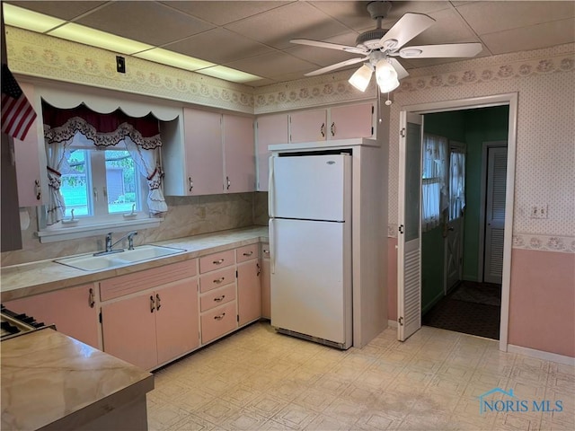 165 5th St, Mcclure, OH 43534 - kitchen with freestanding refrigerator, wallpapered walls, light countertops, a ceiling fan, and light flooring
