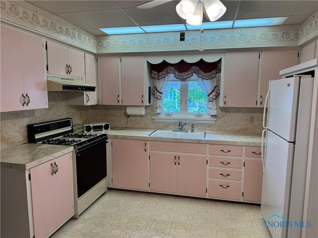 165 5th St, Mcclure, OH 43534 - kitchen featuring freestanding refrigerator, range with gas cooktop, under cabinet range hood, a sink, and light countertops