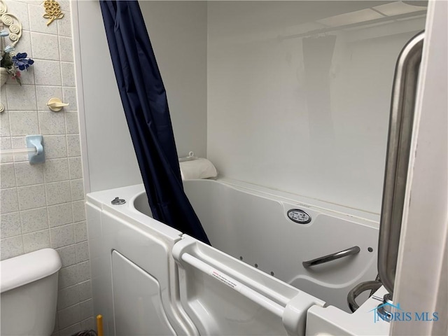 165 5th St, Mcclure, OH 43534 - full bath with tile walls, toilet, and shower / bath combo