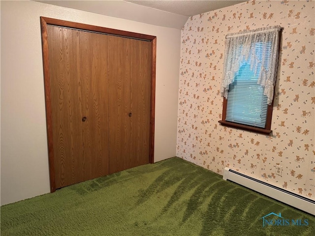 165 5th St, Mcclure, OH 43534 - unfurnished bedroom with a baseboard heating unit, carpet flooring, wallpapered walls, and a closet