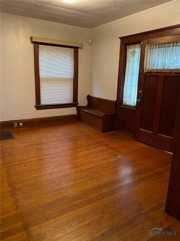862 Prouty Ave, Toledo, OH 43609 - empty room featuring wood finished floors and ornamental molding