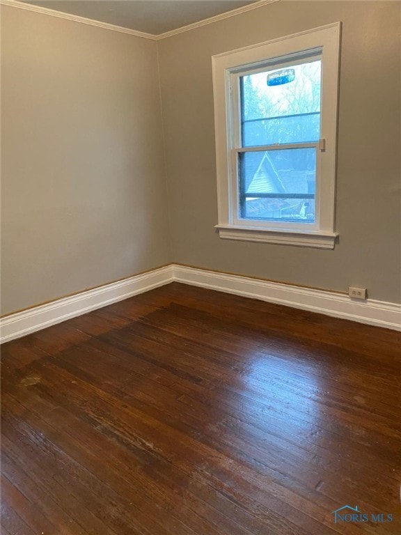 862 Prouty Ave, Toledo, OH 43609 - unfurnished room featuring dark wood-style floors, ornamental molding, and baseboards