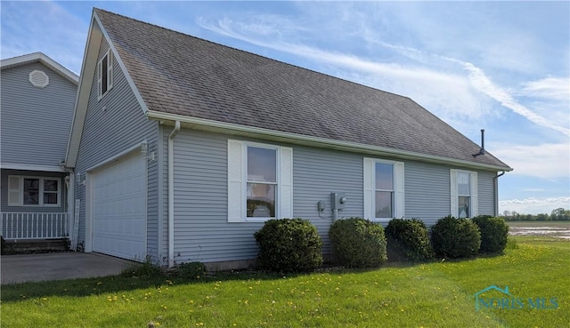 2450 N Billman Rd, Genoa, OH 43430 - view of side of home with a lawn, driveway, and roof with shingles