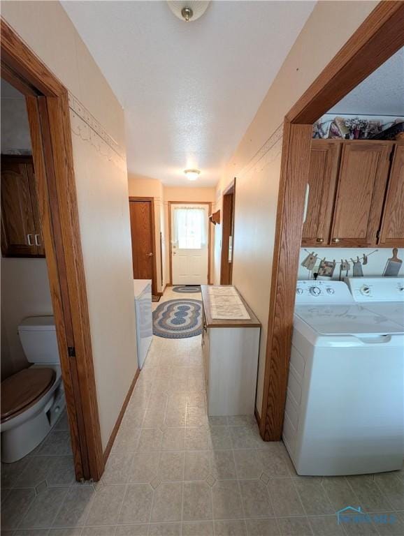 2450 N Billman Rd, Genoa, OH 43430 - laundry room with washer / dryer, cabinet space, and light tile patterned floors