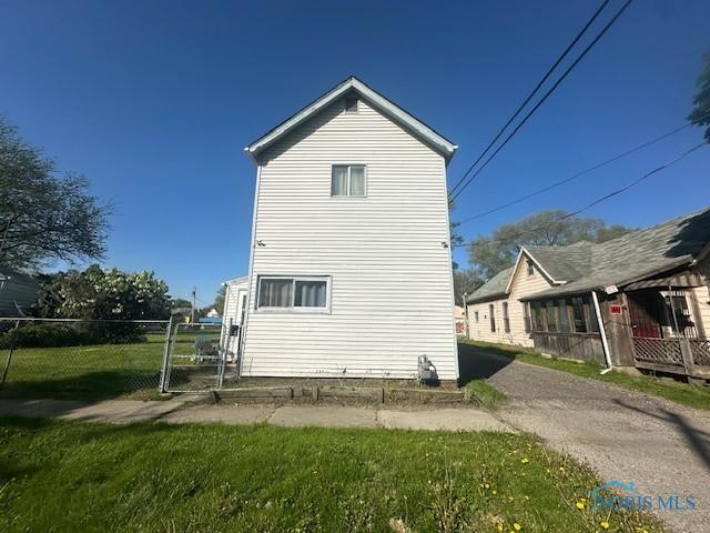 2111 Elm St, Toledo, OH 43608 - view of side of property featuring a gate and fence