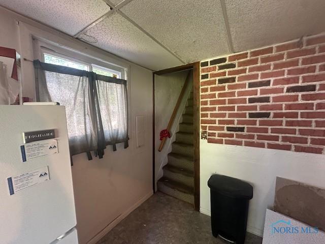 2111 Elm St, Toledo, OH 43608 - below grade area with stairway and freestanding refrigerator