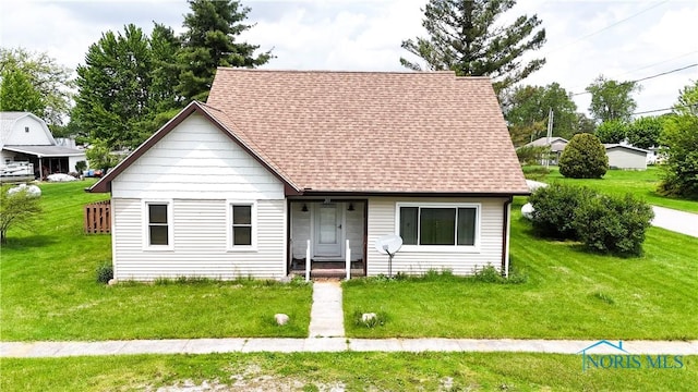 203 E Ash St, Continental, OH 45831 - view of front of house with a shingled roof and a front yard