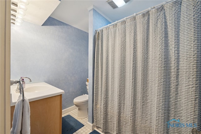 bathroom featuring toilet, crown molding, tile patterned floors, vanity, and baseboards
