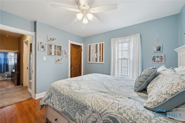 bedroom with wood finished floors, baseboards, and ceiling fan