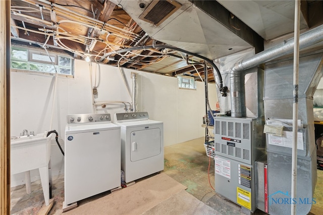 below grade area featuring washer and dryer and a sink