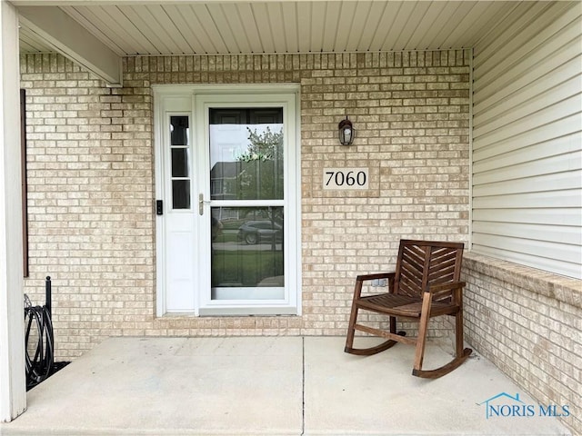 entrance to property with brick siding