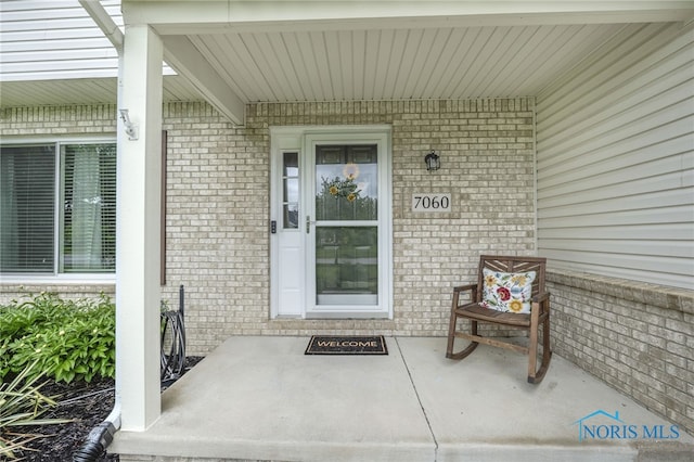 7060 Joannes Way, Maumee, OH 43537 - doorway to property with brick siding and a porch