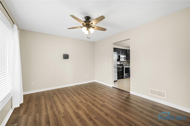 7060 Joannes Way, Maumee, OH 43537 - unfurnished room featuring dark wood-style flooring, ceiling fan, and baseboards