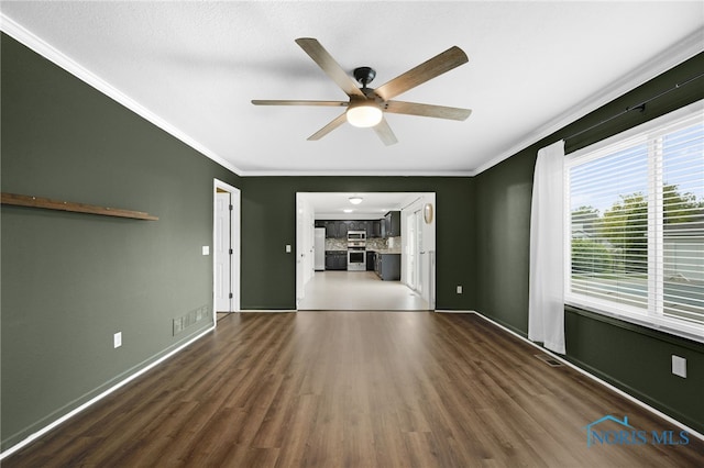 7060 Joannes Way, Maumee, OH 43537 - unfurnished living room with ornamental molding, a ceiling fan, dark wood finished floors, and baseboards