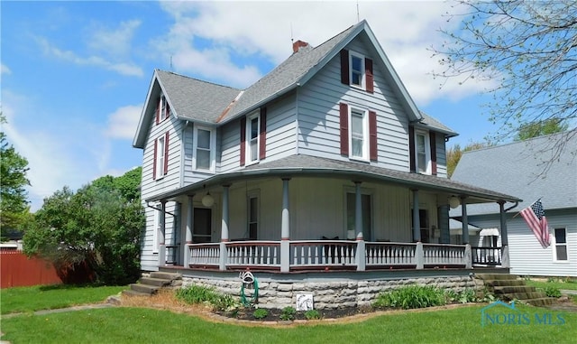 203 N Union St, Fostoria, OH 44830 - view of front of property with a porch, a shingled roof, and a front lawn
