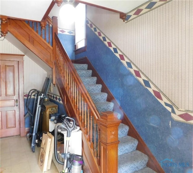 203 N Union St, Fostoria, OH 44830 - staircase with wallpapered walls and tile patterned floors