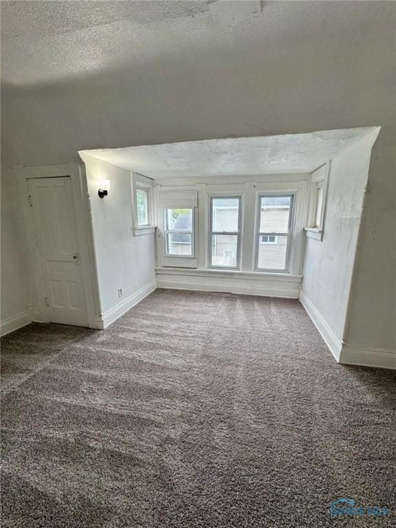 2108 N Michigan St, Toledo, OH 43611 - spare room featuring baseboards, a textured ceiling, and carpet floors