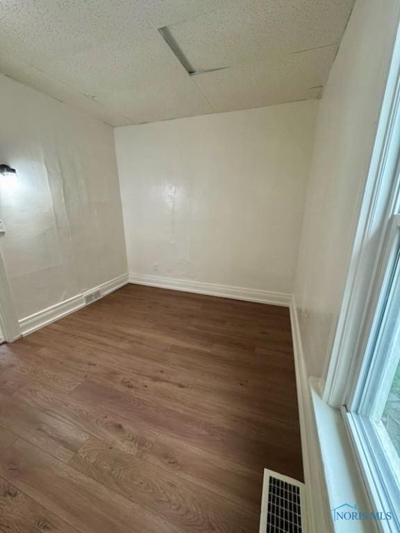 2108 N Michigan St, Toledo, OH 43611 - spare room with dark wood-style flooring and baseboards