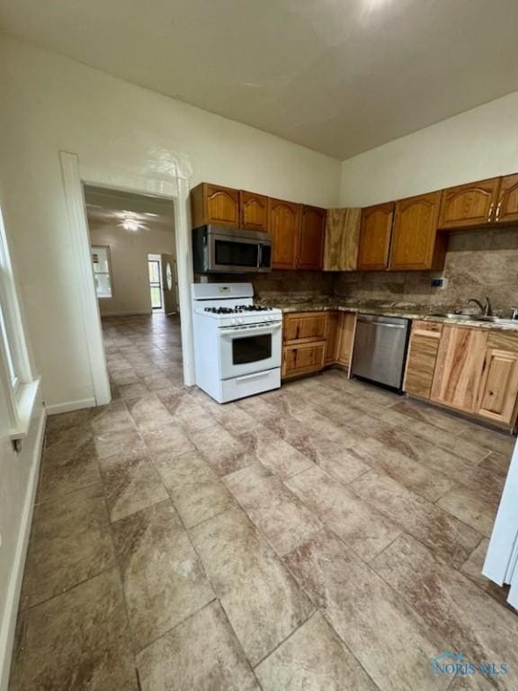 2108 N Michigan St, Toledo, OH 43611 - kitchen featuring stainless steel appliances, a sink, tasteful backsplash, and brown cabinets