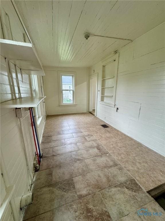 2108 N Michigan St, Toledo, OH 43611 - spare room with stone finish flooring and wooden ceiling