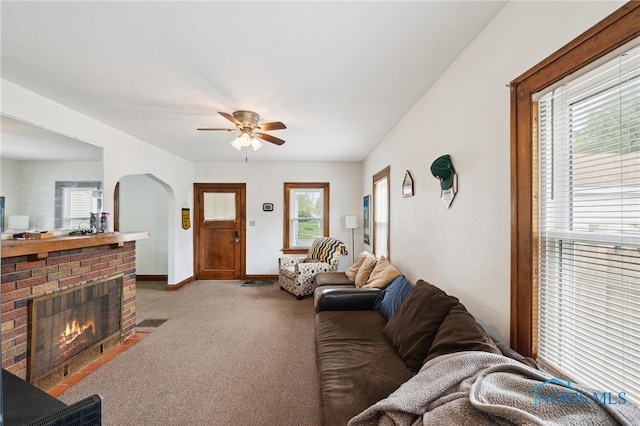 2352 108th St, Toledo, OH 43611 - living area with carpet floors, ceiling fan, a fireplace, and arched walkways