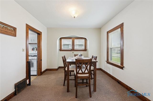 2352 108th St, Toledo, OH 43611 - carpeted dining room featuring arched walkways and baseboards