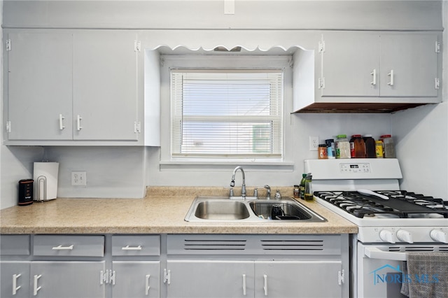 2352 108th St, Toledo, OH 43611 - kitchen featuring white gas stove and light countertops