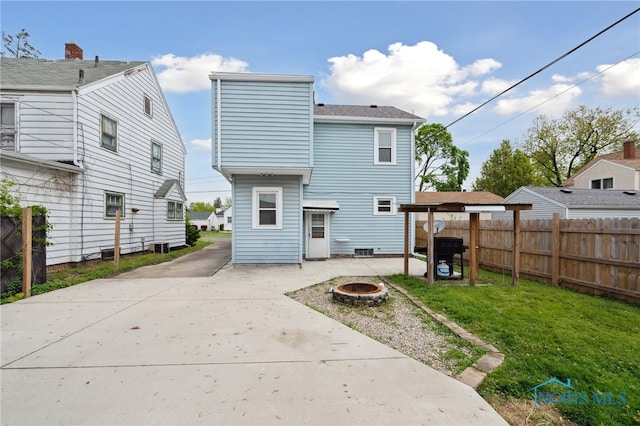 2352 108th St, Toledo, OH 43611 - back of property with a fire pit, a patio area, and concrete driveway