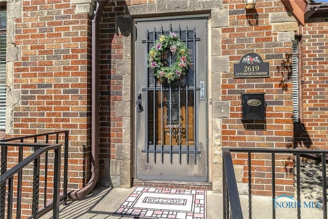 property entrance with brick siding