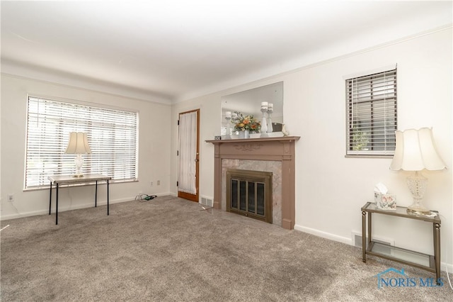 carpeted living room with a fireplace and baseboards