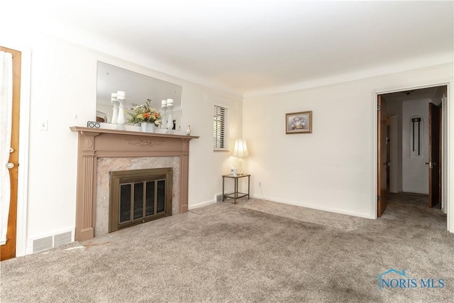 unfurnished living room featuring carpet flooring and a high end fireplace