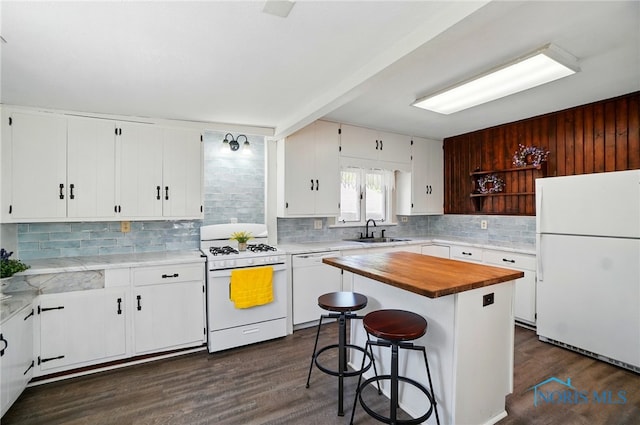 kitchen with white appliances, a sink, wooden counters, backsplash, and dark wood-style floors